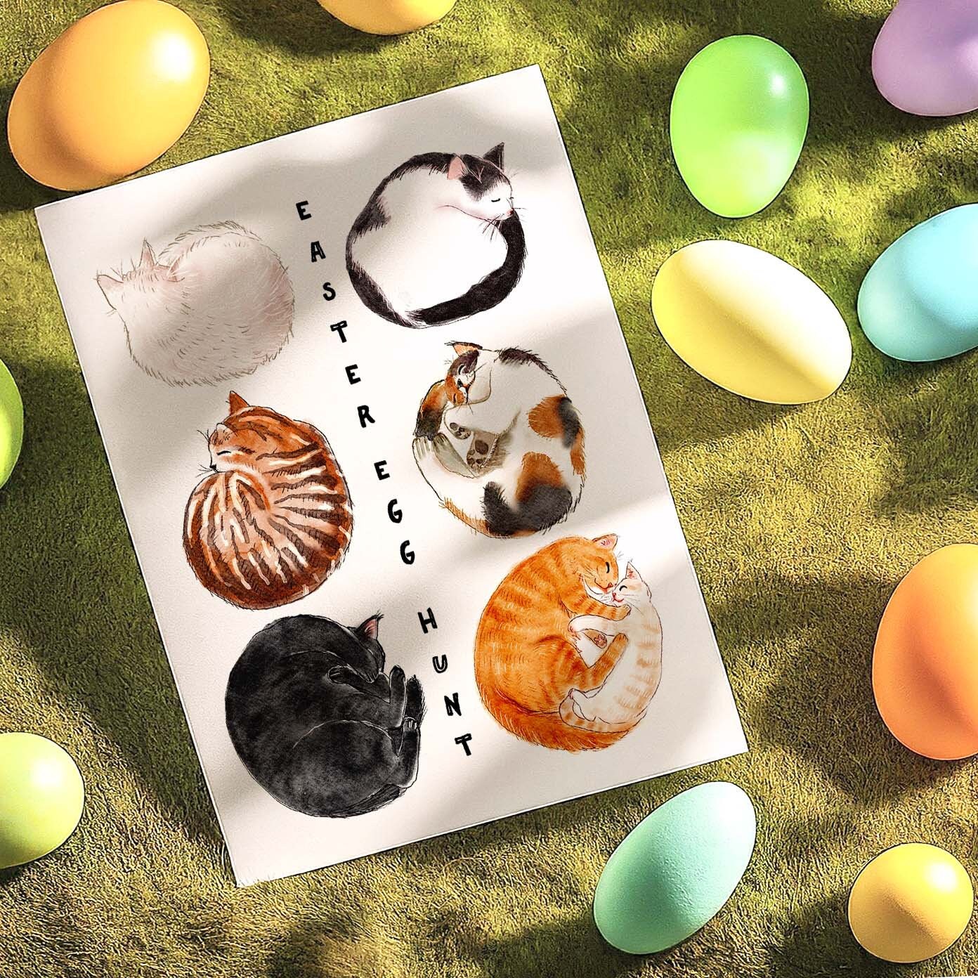 Easter Egg Hunt card featuring six cats curled up like eggs: white cat, black cat, tuxedo cat, brown tabby cat, calico cat, and an orange cat mom with her kitten. Perfect for cat lovers!